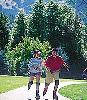 A couple roller blading on the pathway